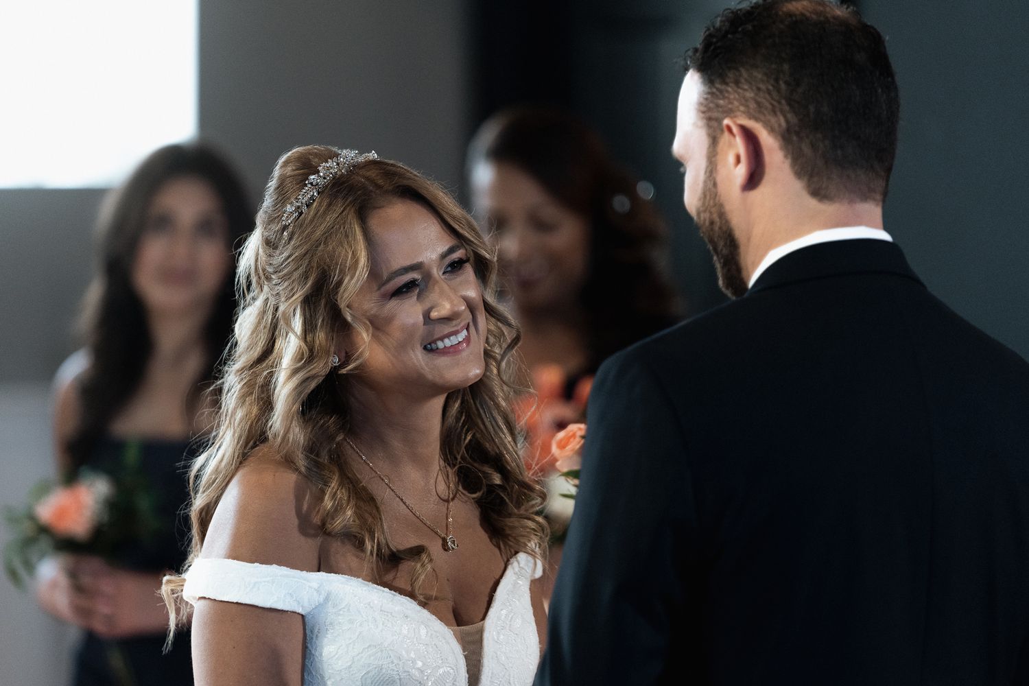 Wedding ceremony in modern indoor venue with natural lighting.