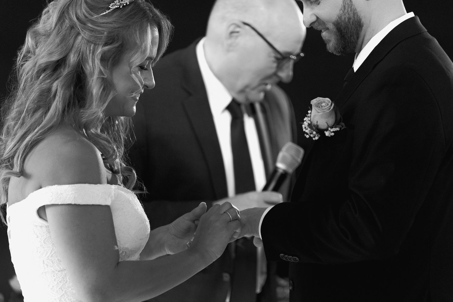Candid black and white moment between newlyweds during their ceremony.