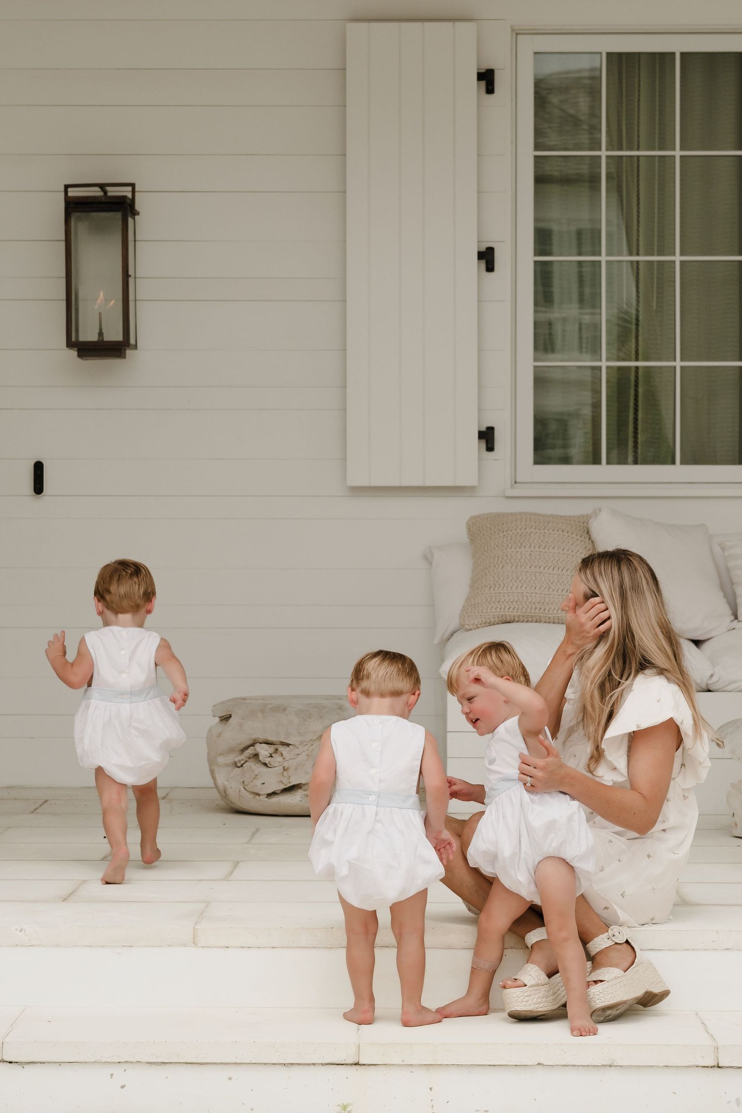 Candid moments of family playtime on a white porch.