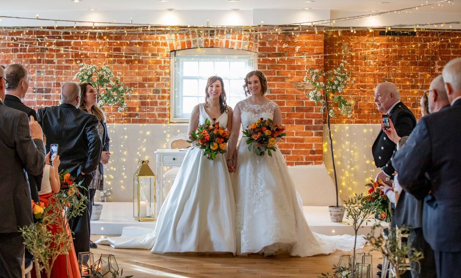 Rustic wedding venue with exposed brick walls and elegant white decor.