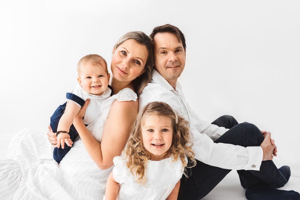 all white family with toddlers photos in all-white studio Hereford