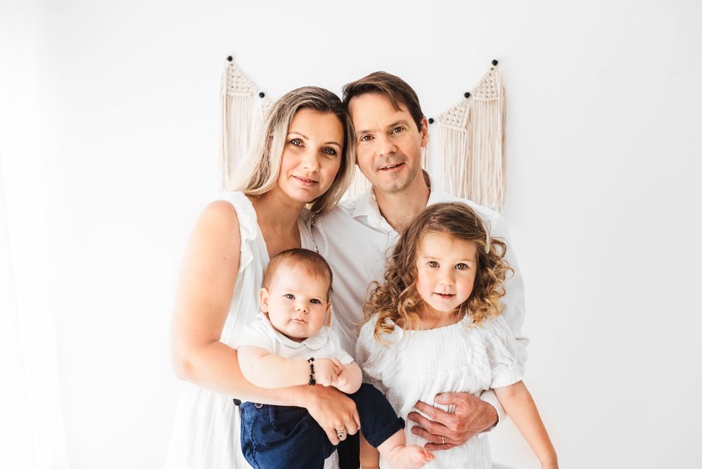 all white family with toddlers photos in all-white studio Hereford
