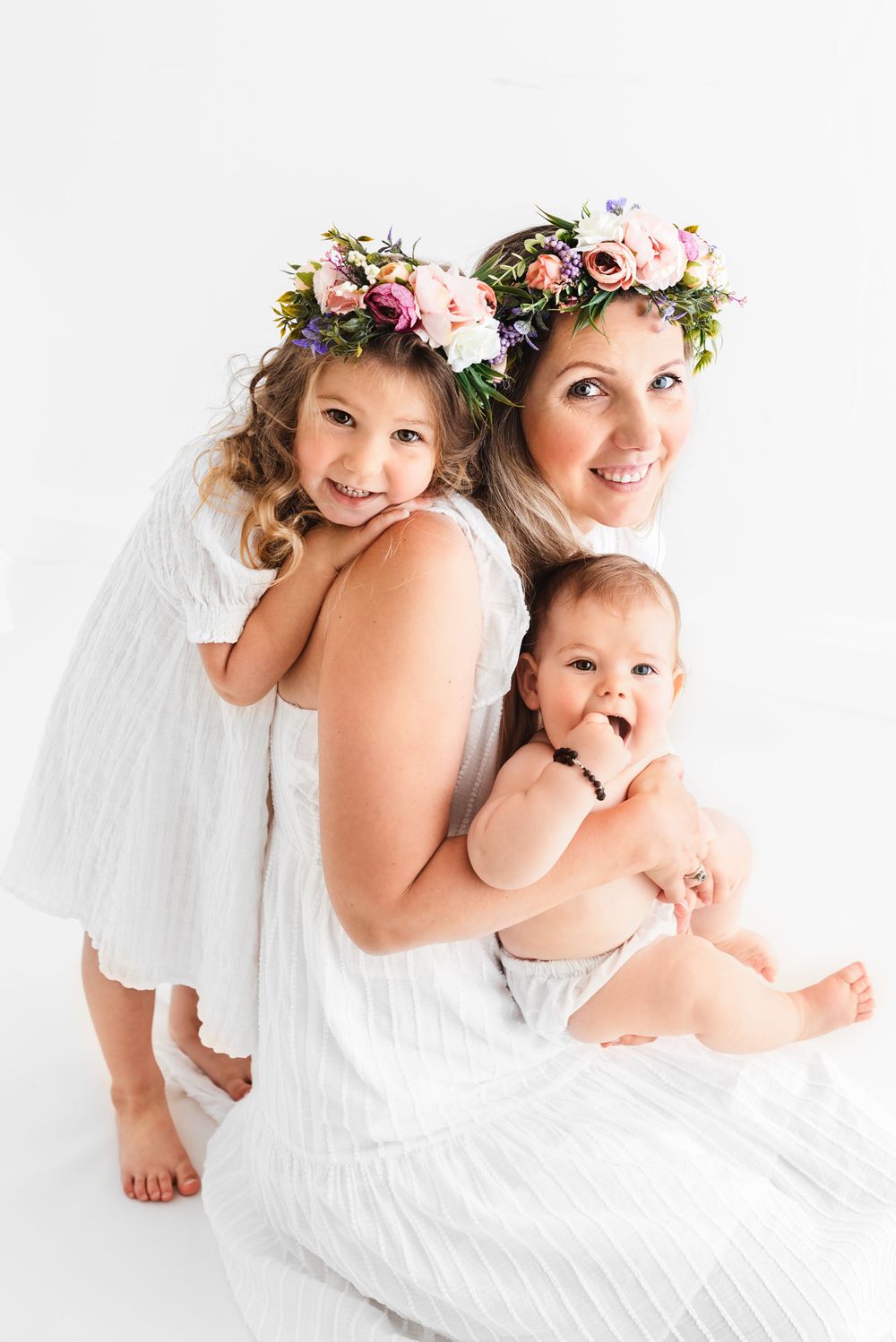 all white family with toddlers photos in all white studio Hereford