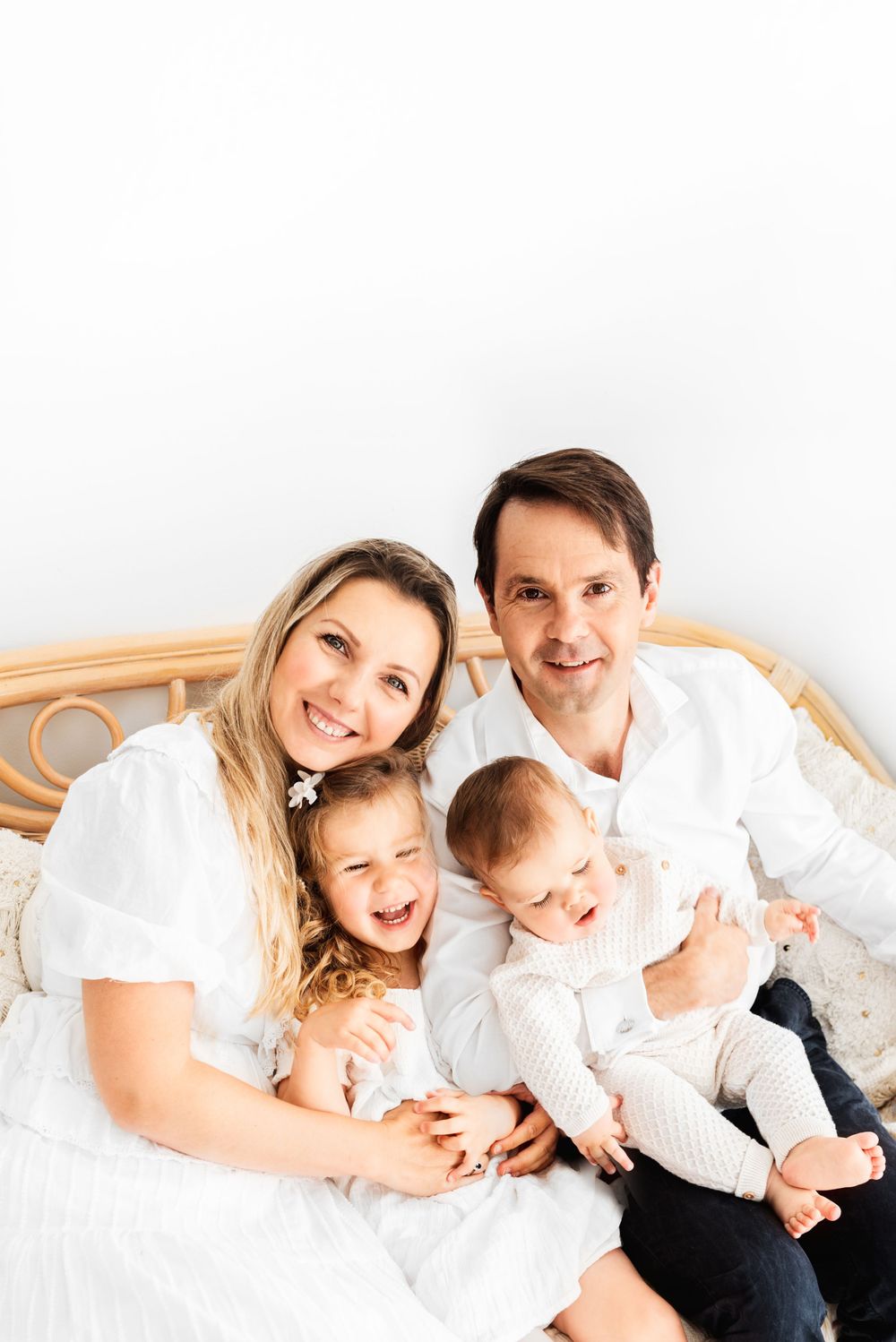 all white family with toddlers photos in all-white studio Hereford