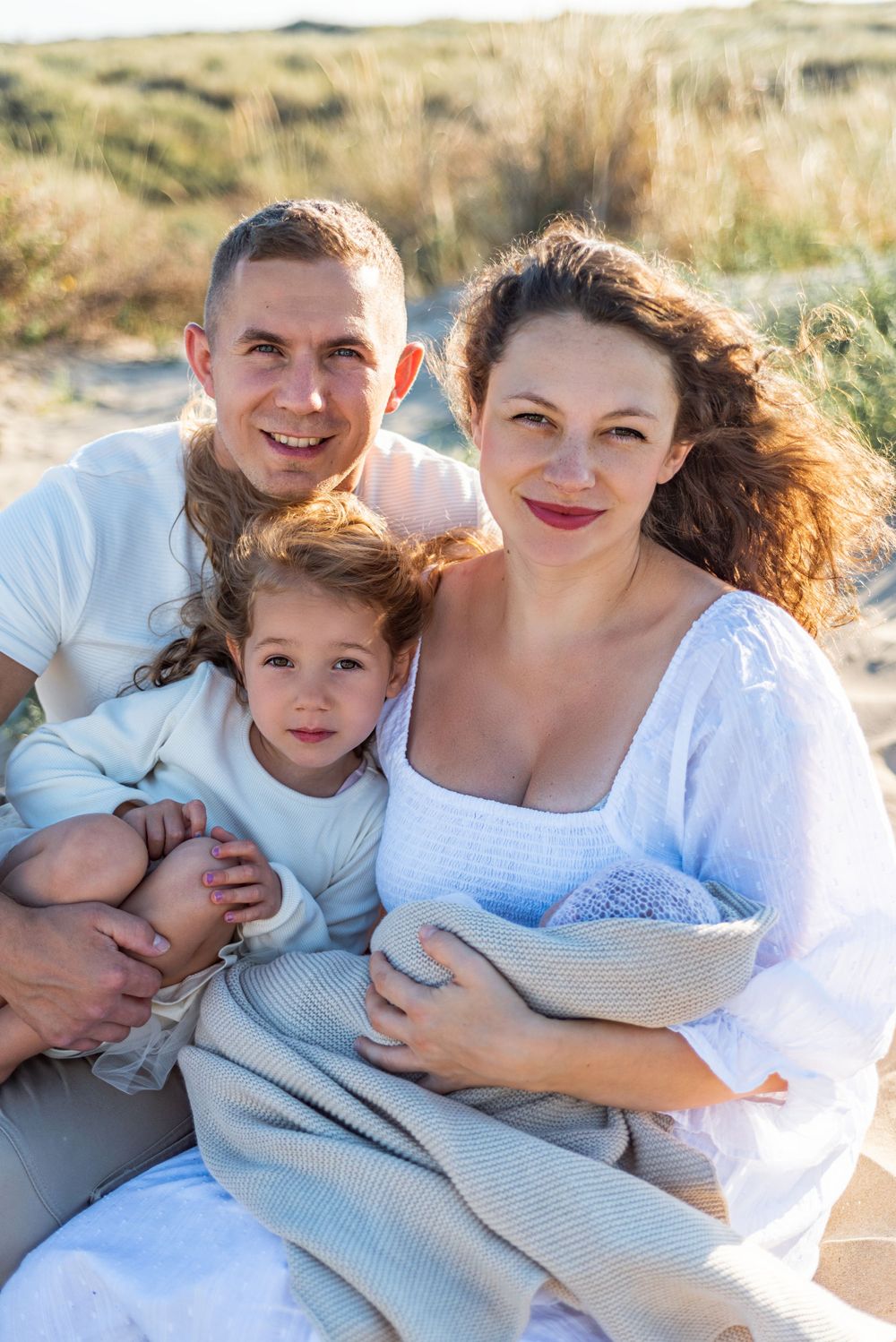 family beach photos with newborn on sand dunes Hereford