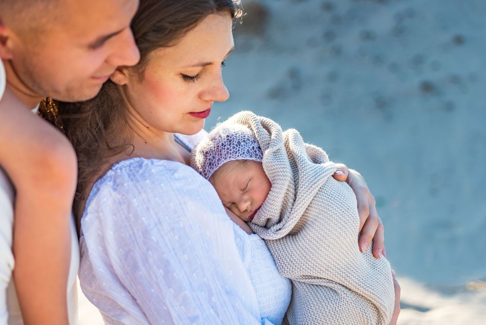 family beach photos with newborn on sand dunes