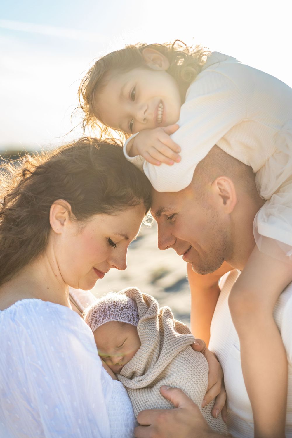 family beach photos with newborn on sand dunes