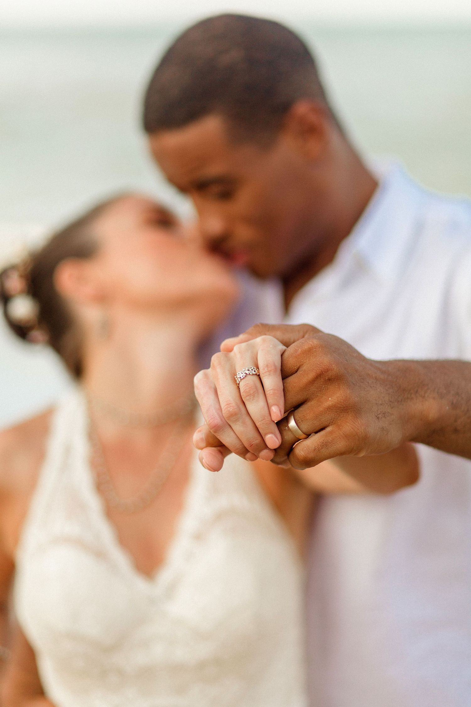 couple holding out rings to camera authentic timeless photograph by photographer in central florida