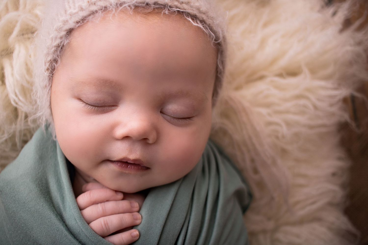 baby boy wrapped in green asleep photographed by newborn photographer swansea