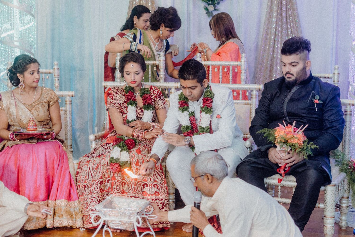 Traditional Hindu wedding ceremony with guests gathered around for sacred rituals.
