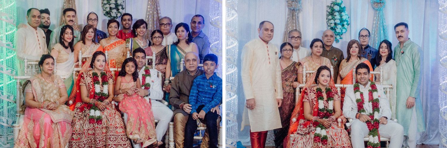 Large family group photo at an Indian wedding with guests in colorful traditional outfits.