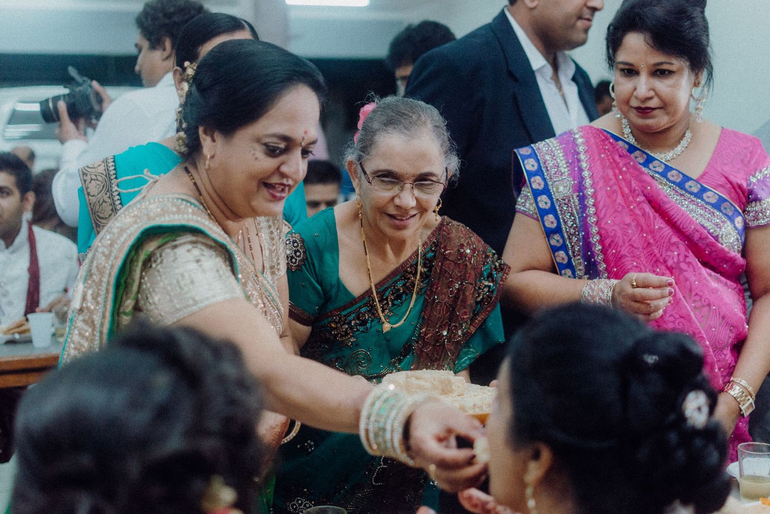 Wedding guests sharing food and participating in traditional customs during the celebration.