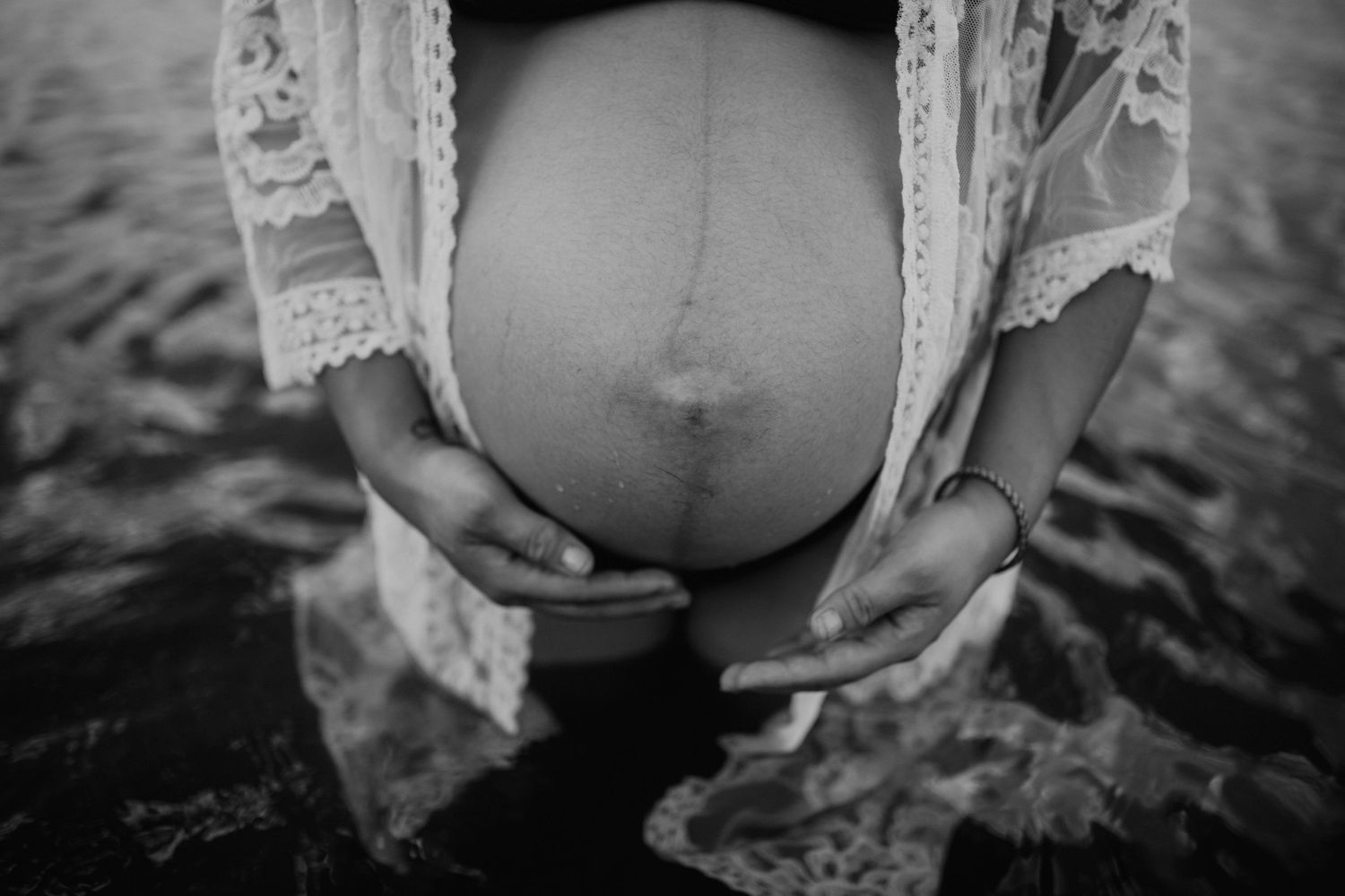 Pregnant woman's belly in water