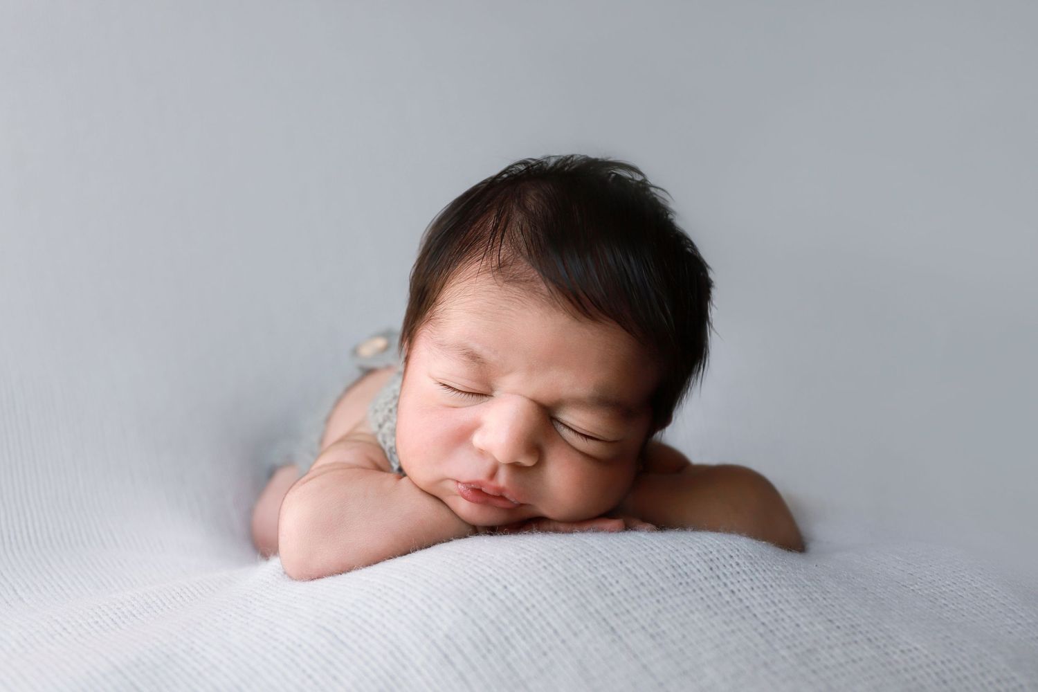 fine art posed newborn, newborn baby boy in knit romper