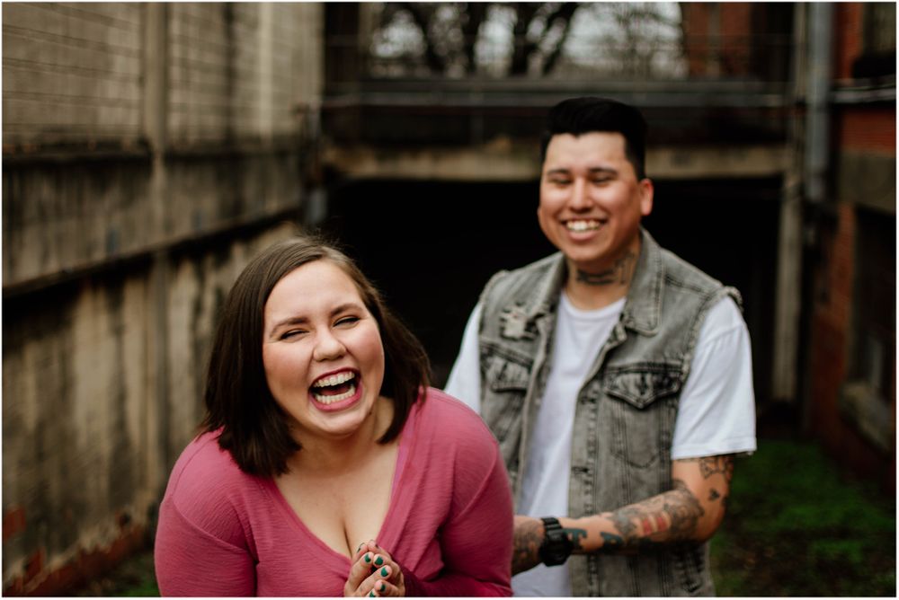 Joyful candid moment captured against urban brick wall background.