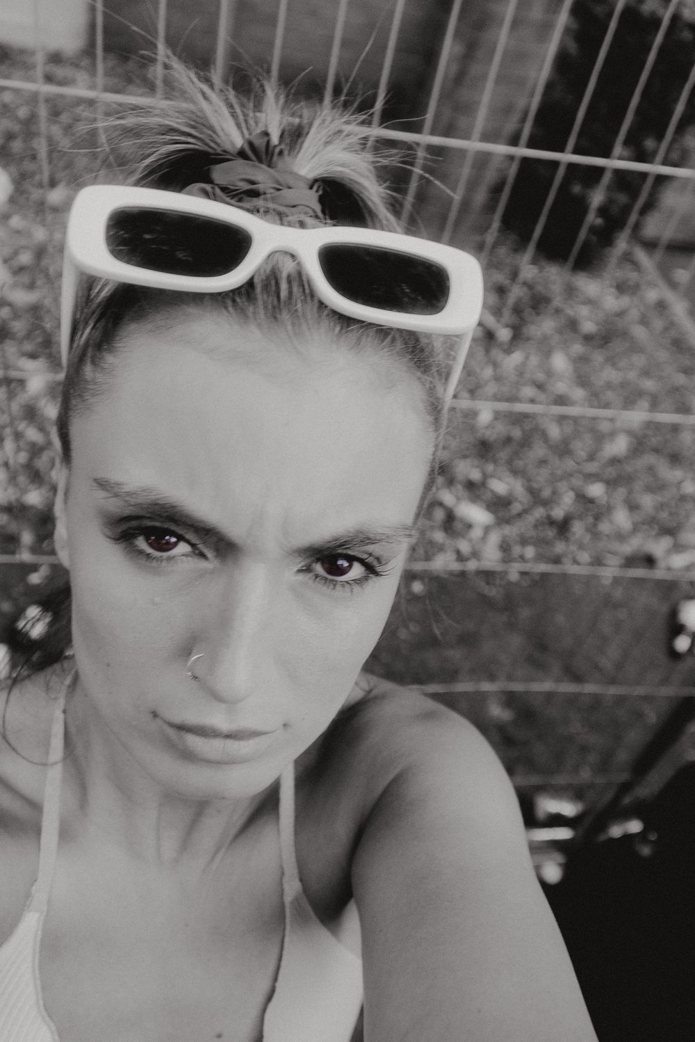 Stylish selfie with white-framed sunglasses in black and white.