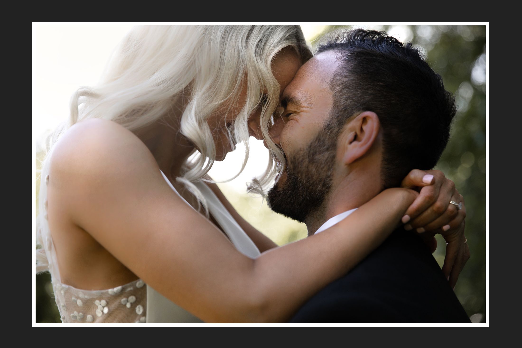 Intimate moment between newlyweds sharing a tender embrace.
