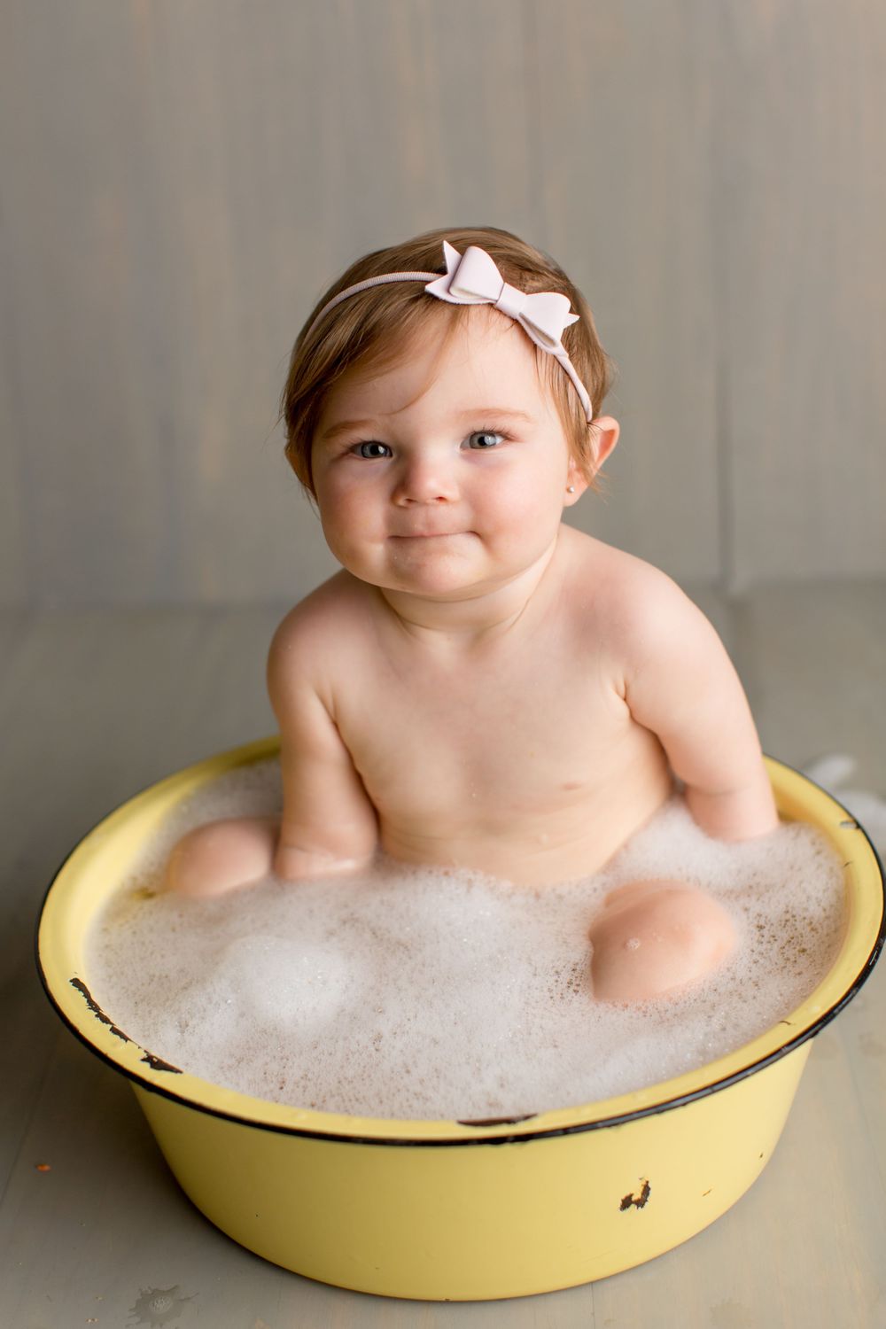 Bath time portrait in a vintage yellow tub filled with bubbles.