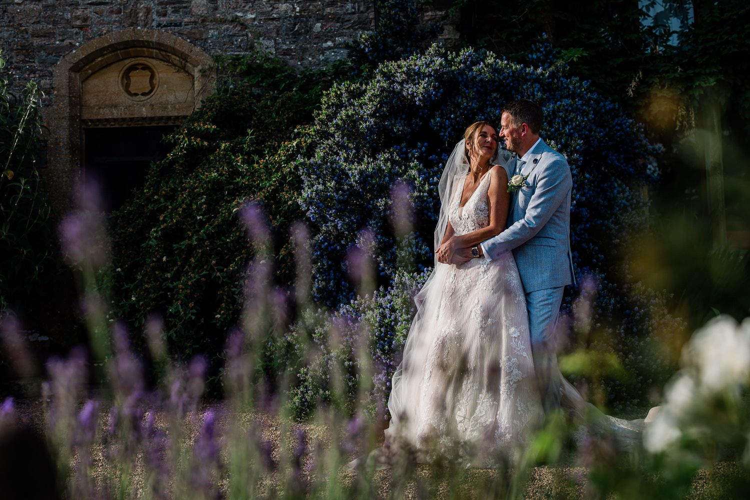 A couple share an intimate moment together during wedding portraits at Devon wedding venue Huntsham Court.