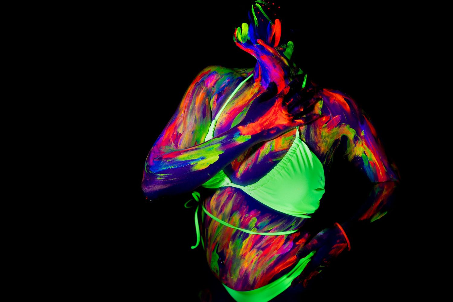 Abstract art featuring swirling neon colors against a black background creates a vibrant fluid pattern.