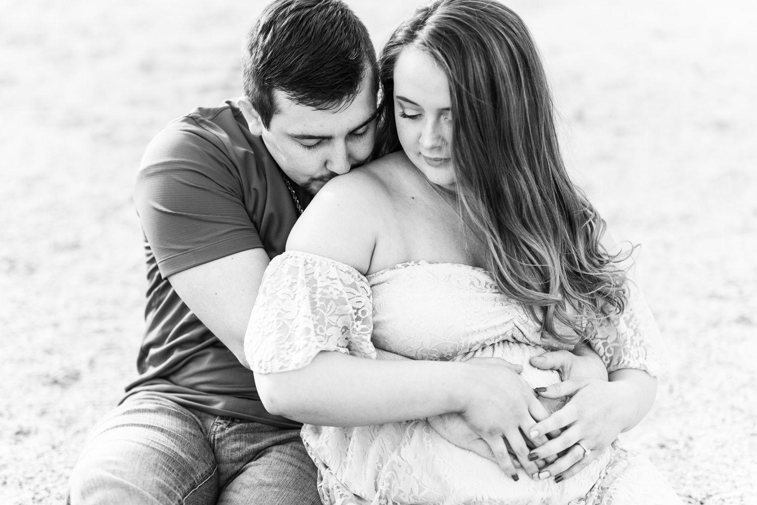 Maternity session with couple on beach in golden hour sunlight at Moraine State Park, Pennsylvania