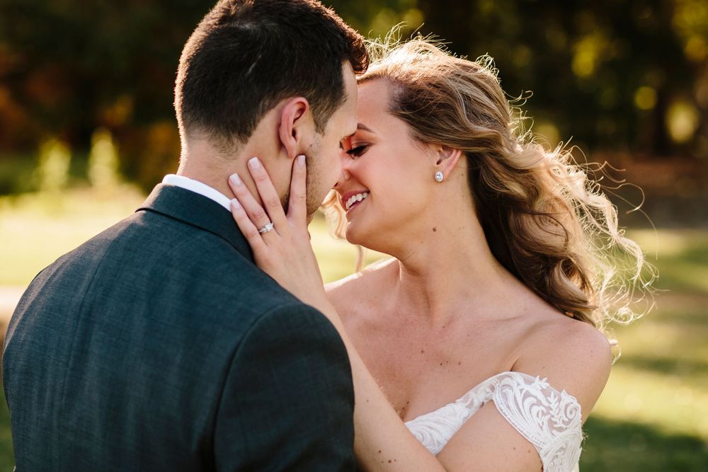 Bride and groom going for a kiss closeup at their Vines Resort wedding