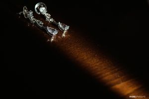 Long exposure night photo of sparklers creating light trails at wedding celebration.