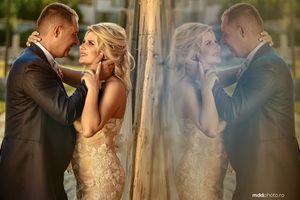 Artistic double exposure wedding portrait showing intimate moment in warm golden light.