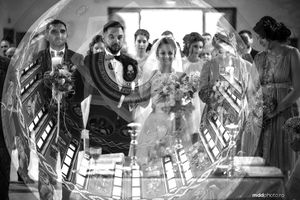 Black and white fisheye view of wedding ceremony with architectural details.