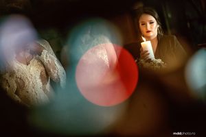 Artistic bokeh portrait with soft focus colored lights and lace details.