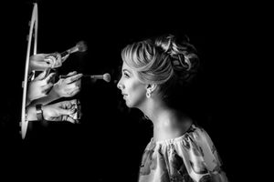 Artistic black and white profile portrait with dramatic side lighting and reflections.