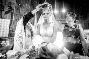 A traditional Orthodox wedding ceremony in progress inside an ornate church.