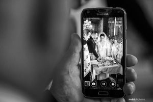 Smartphone capturing wedding reception moment in black and white photography.