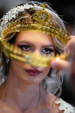 A bridal portrait with shimmering gold accents and a crystal headpiece.