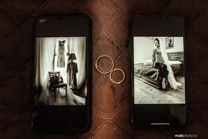 Wedding preparation photos displayed on phones with golden rings arranged on textured surface.