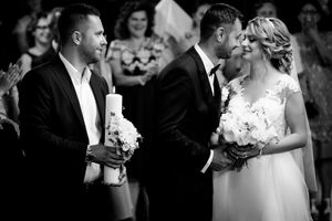 Black and white wedding ceremony photo capturing an intimate moment.