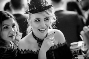 Black and white portrait of someone in vintage attire with a small top hat.