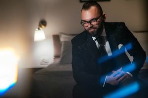Moody portrait with dramatic blue lighting of formal attire.