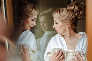 An elegant bridal reflection captured in a mirror while getting ready for the wedding day.
