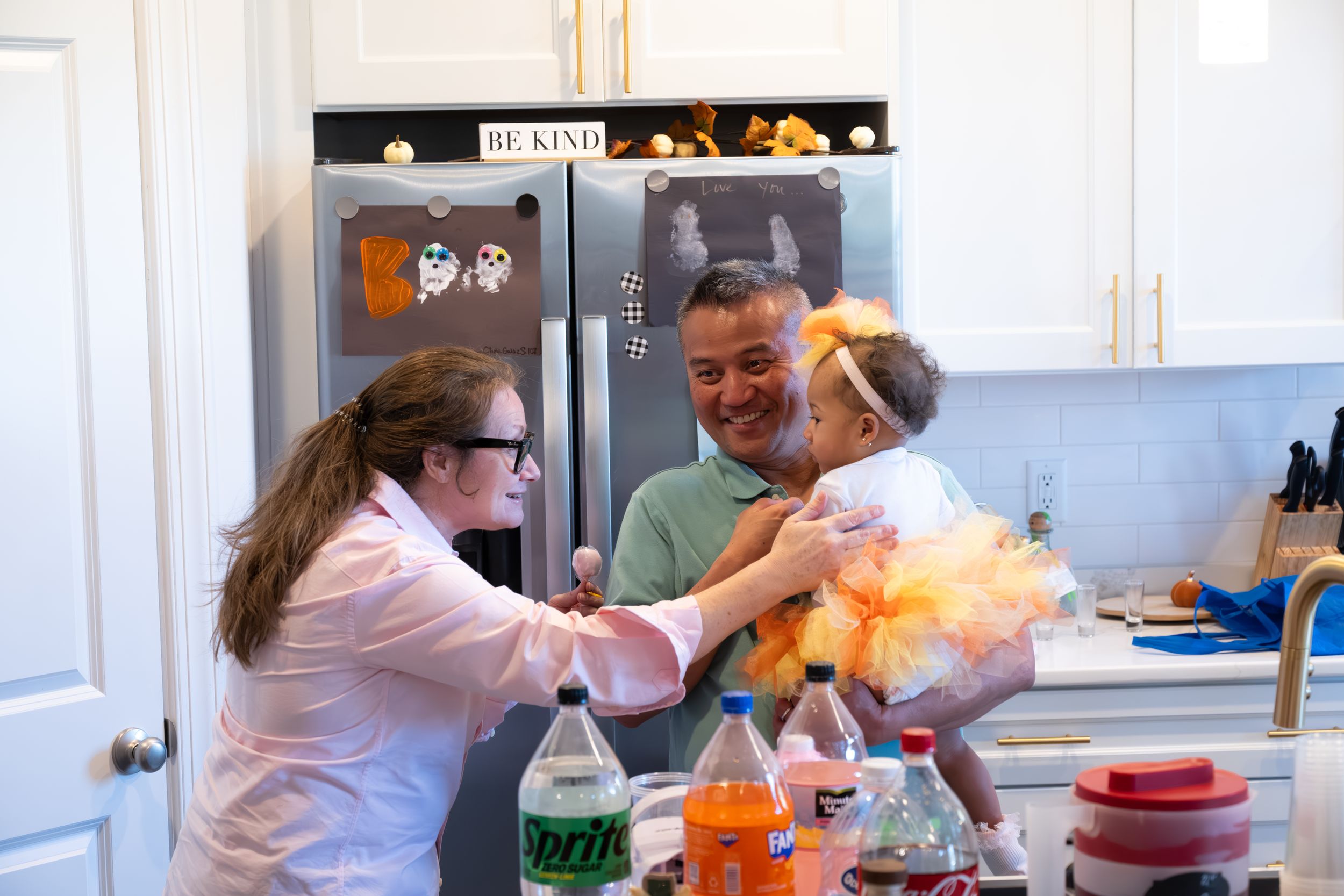 Party preparation scene in kitchen with colorful balloon and drink setup.