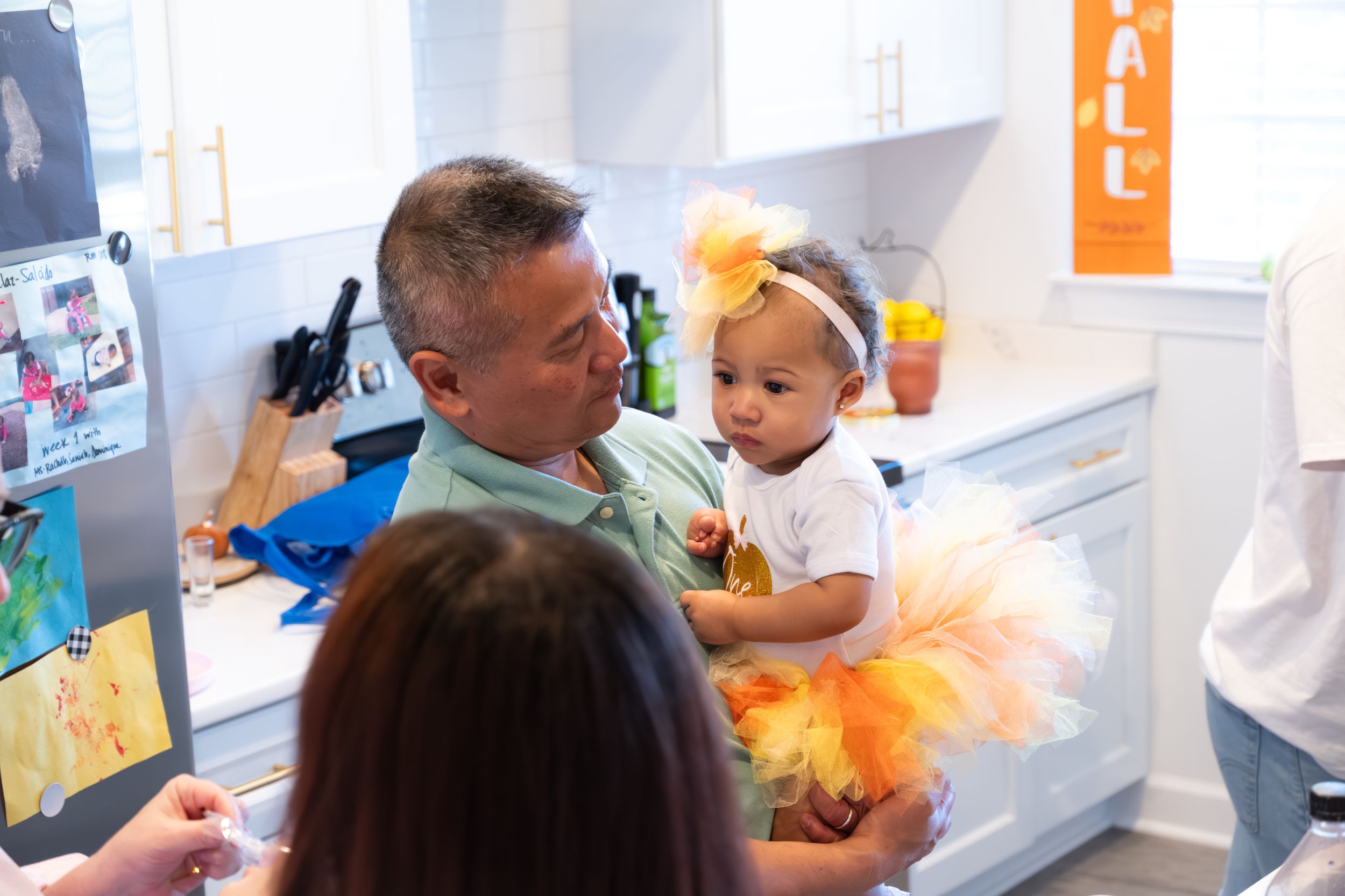 Kitchen party scene with festive autumn decorations and tulle accents.
