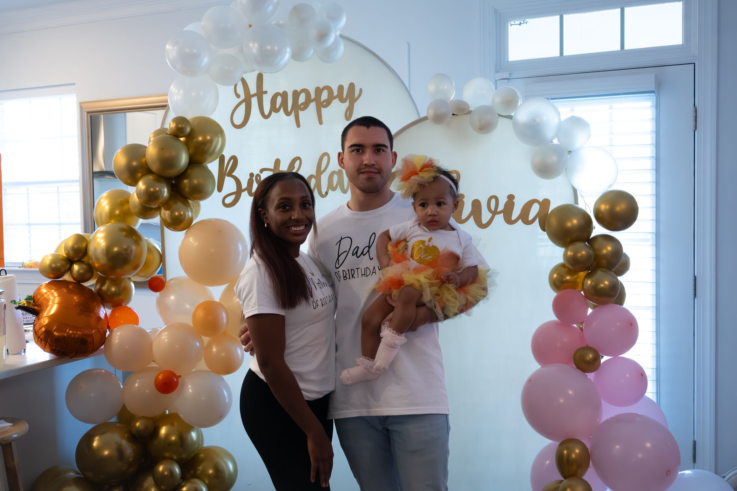 Celebratory scene with elegant balloon decorations and happy birthday signage.