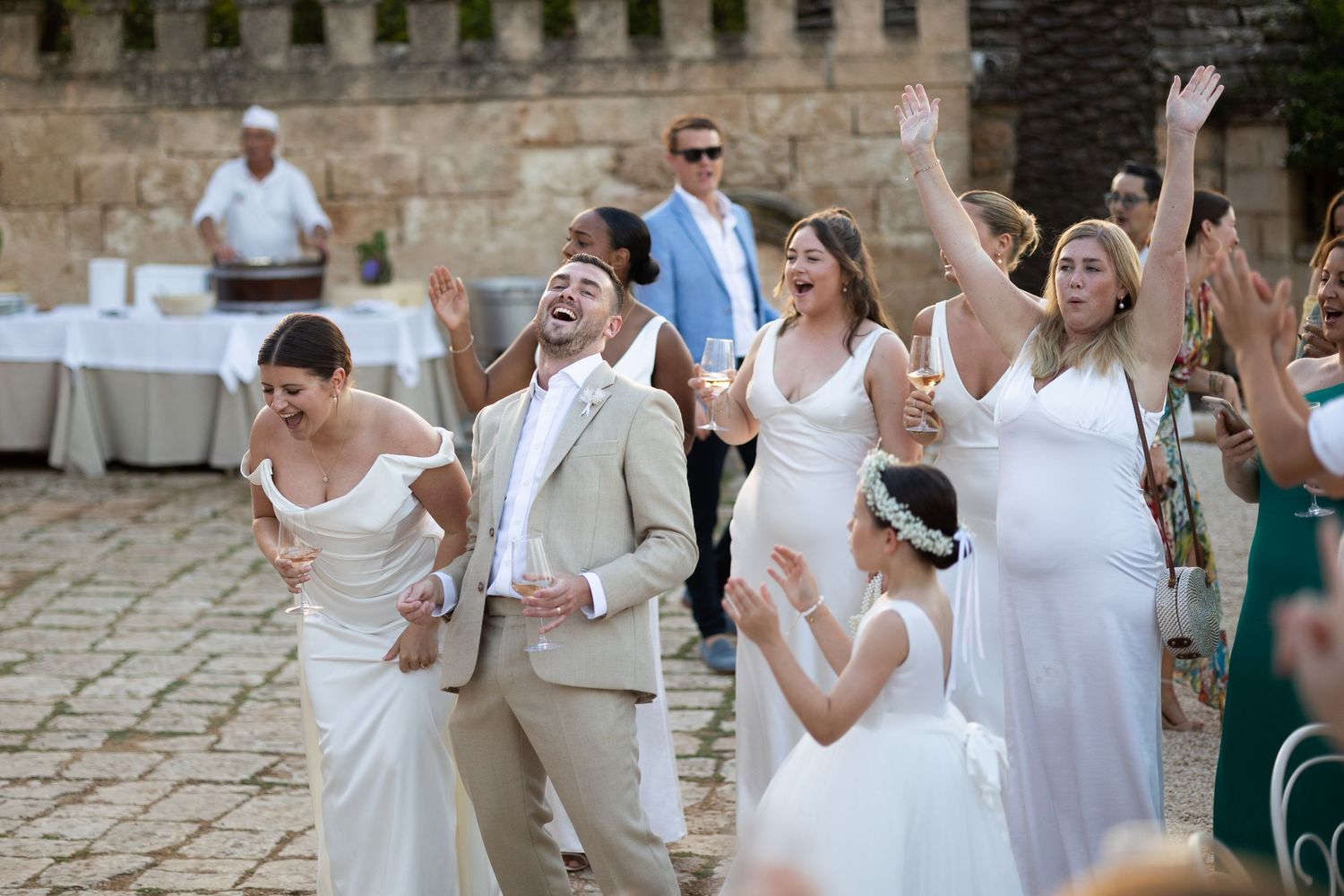 Bride and Groom laughing with their guests at a wedding