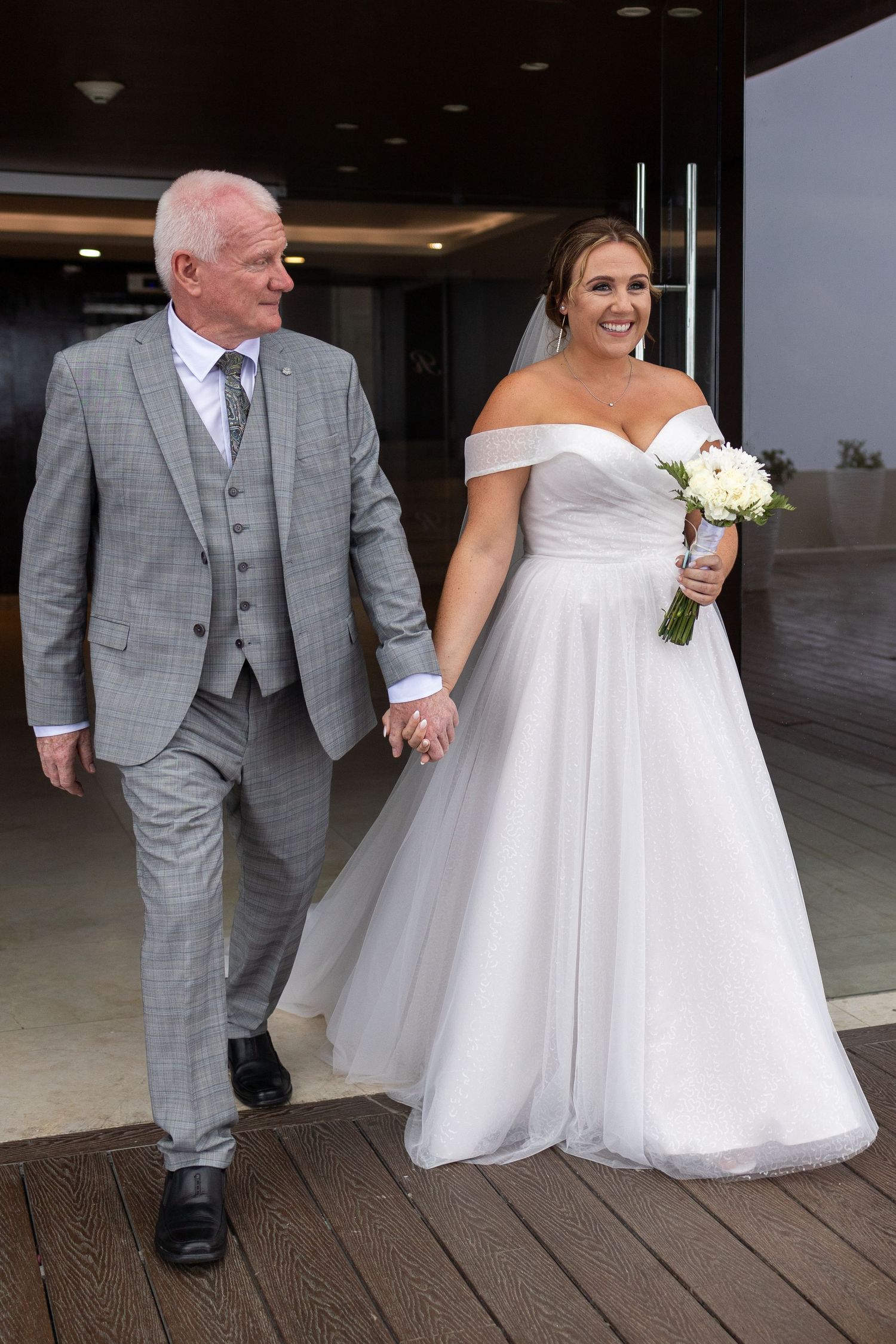 Bride and father of the bride walking down the aisle