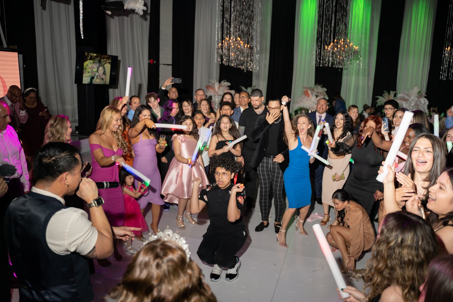 Large group of party guests dancing and celebrating on a dance floor