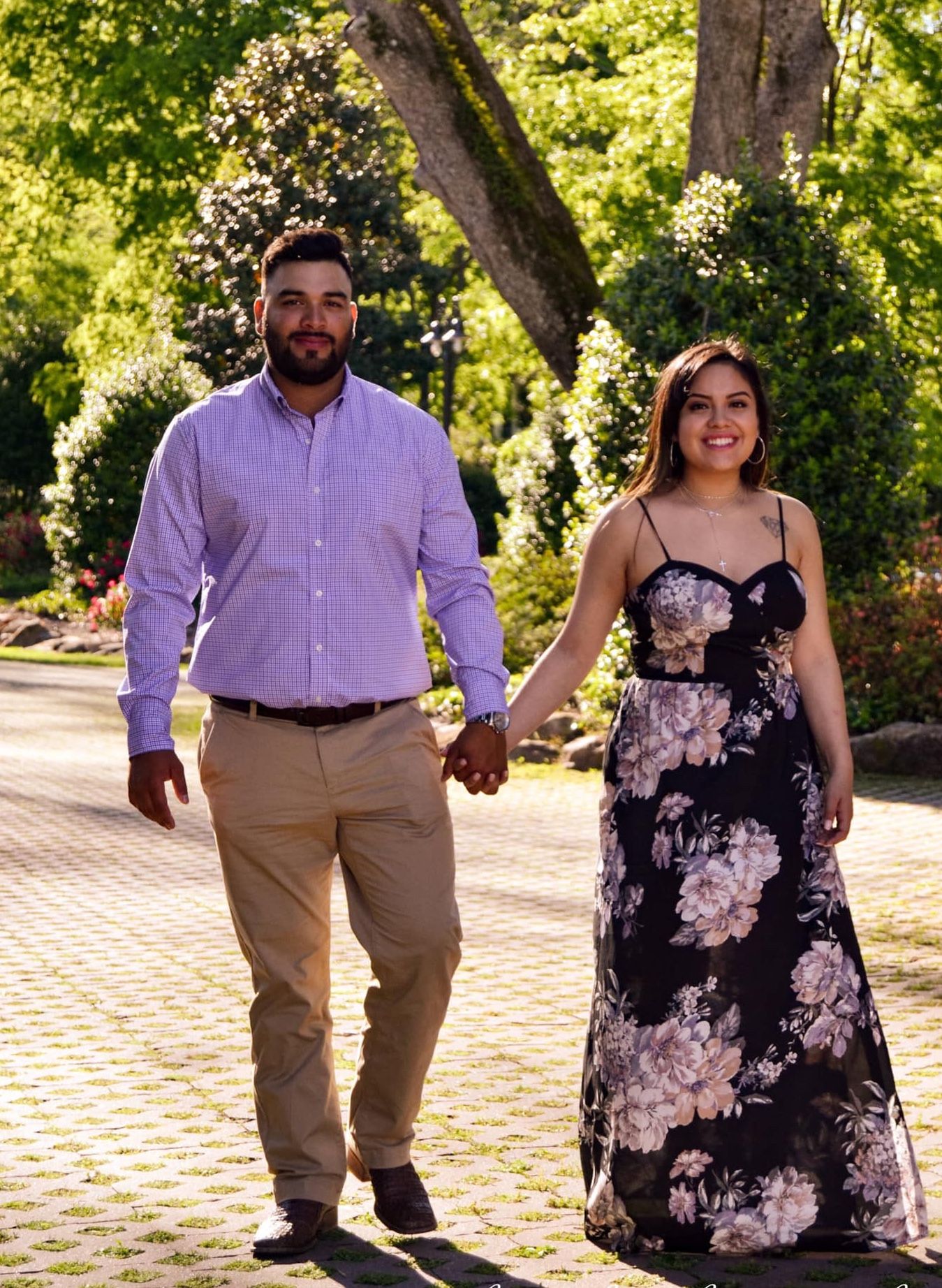 Romantic couple photos in coordinating purple outfits on a brick path.