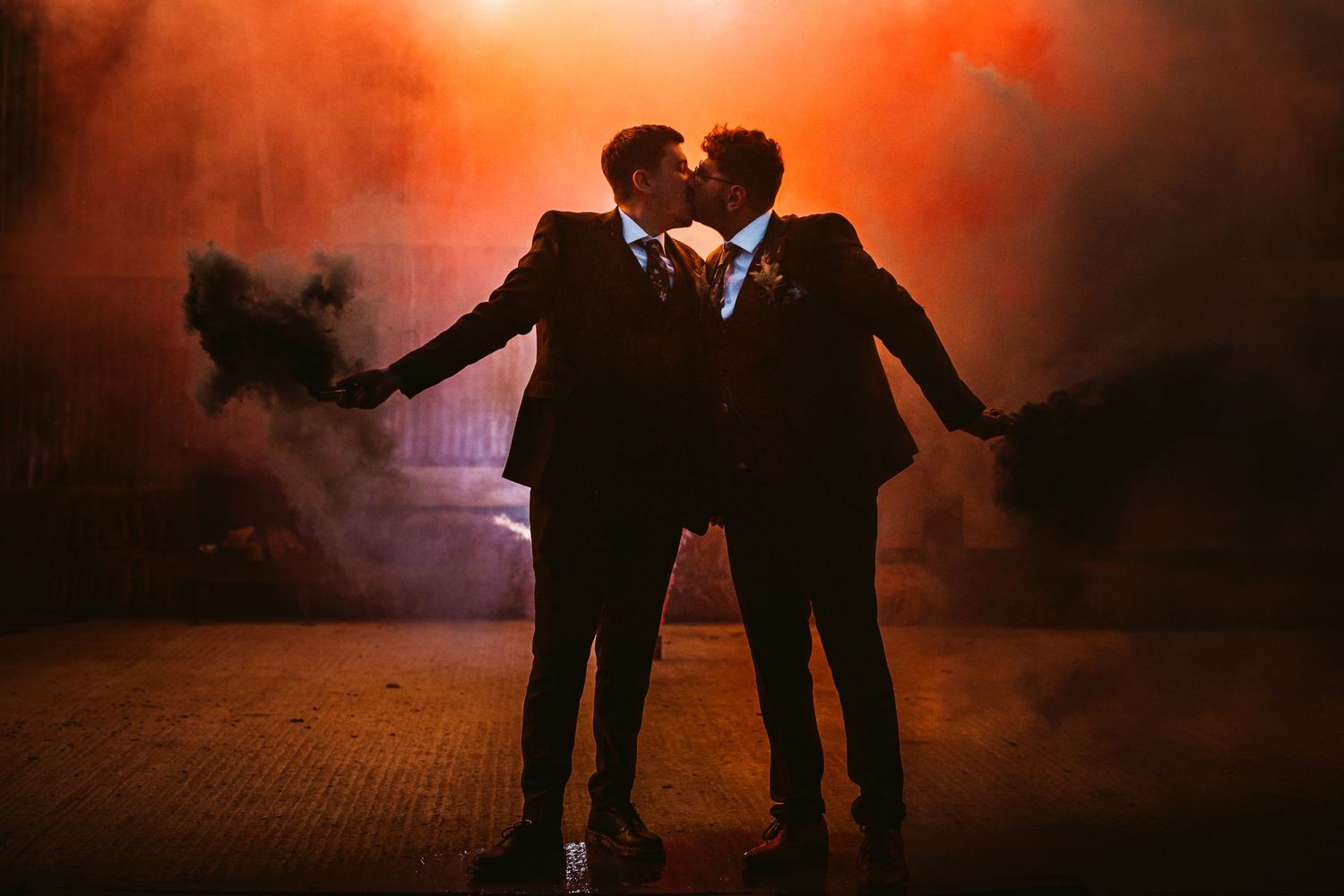Dramatic silhouette portrait with orange smoke effects in evening setting.