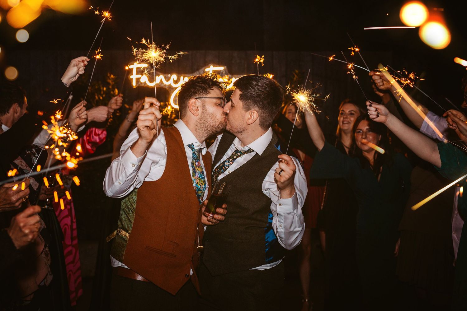 Celebration with sparklers during a special moment surrounded by cheering guests.