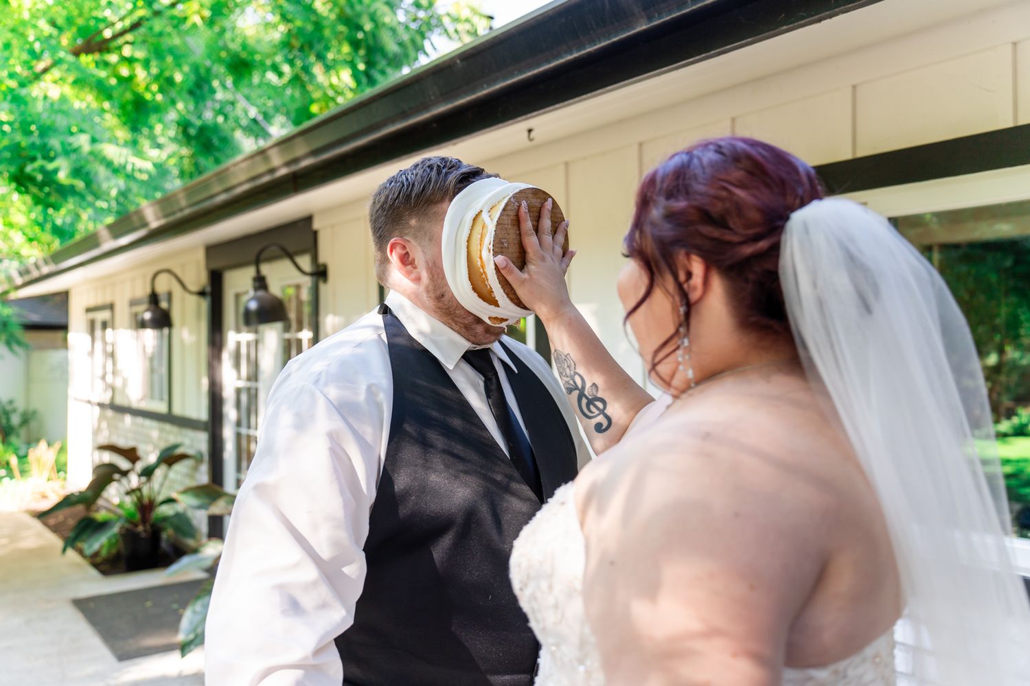 bride puts cake in the groom's face