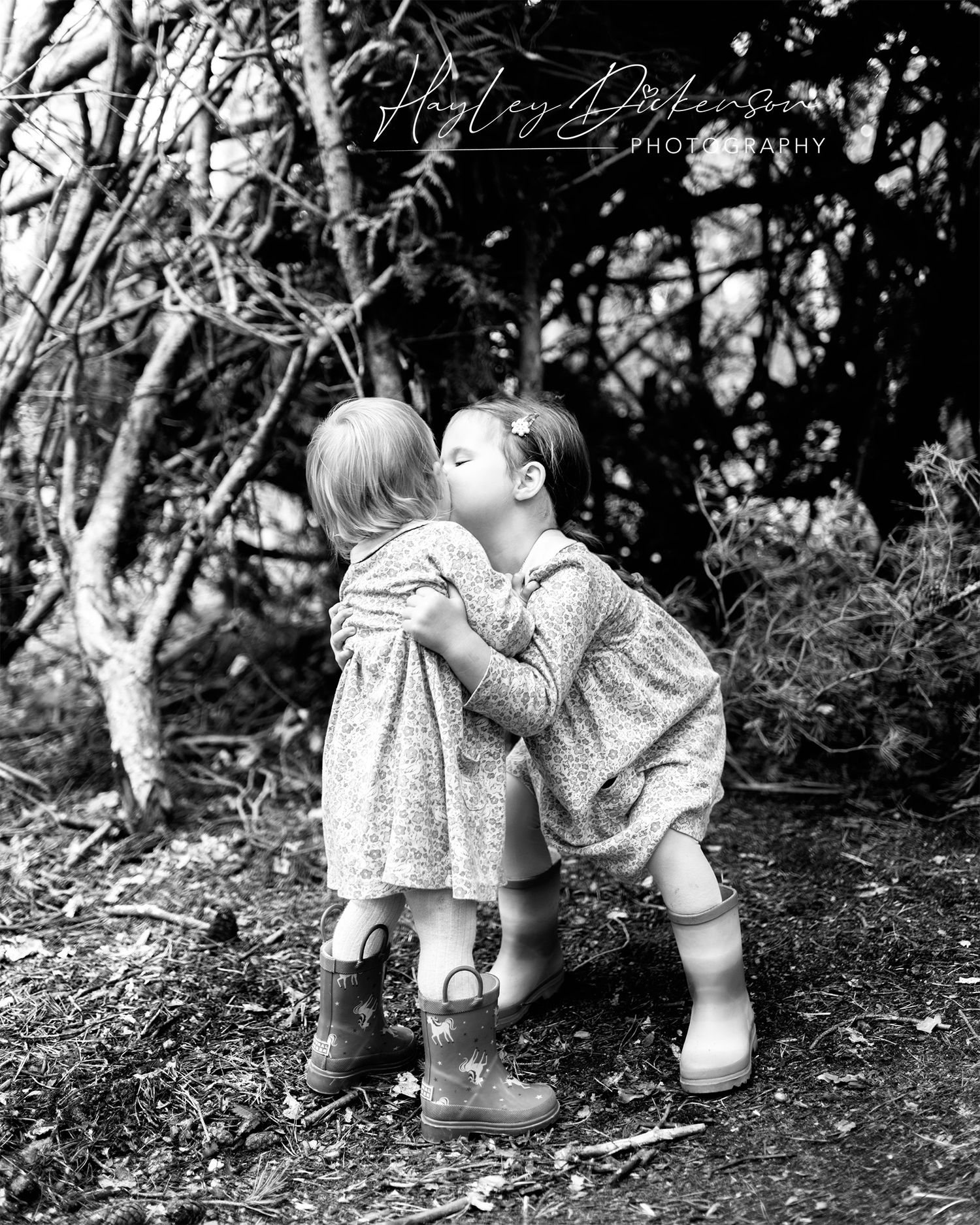 Hayley Dickenson Photography Studio - two sisters cuddling in woods